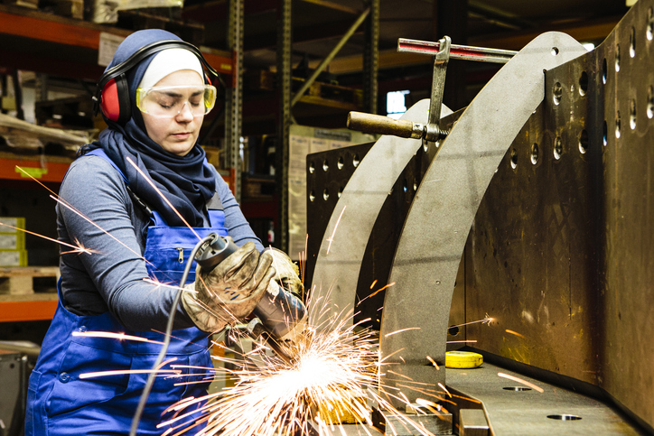 higabi woman using a grinder on a machine
